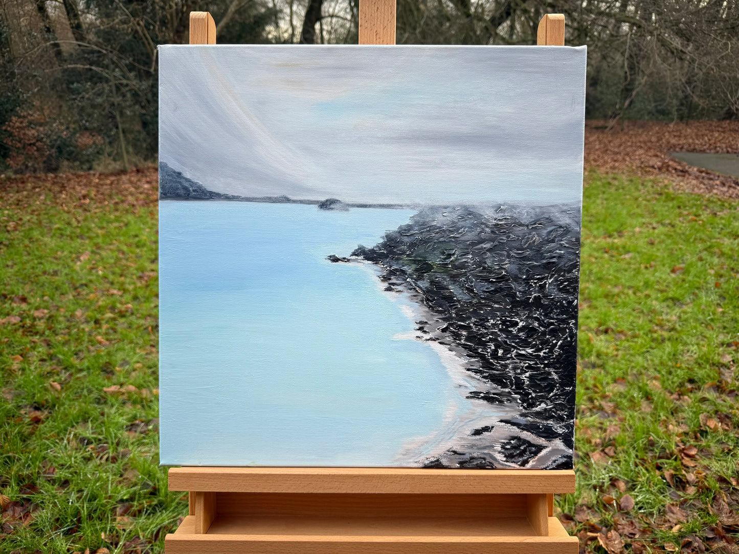 Romantic abstract oil painting of a tranquil blue lagoon with misty sky and rocky shoreline