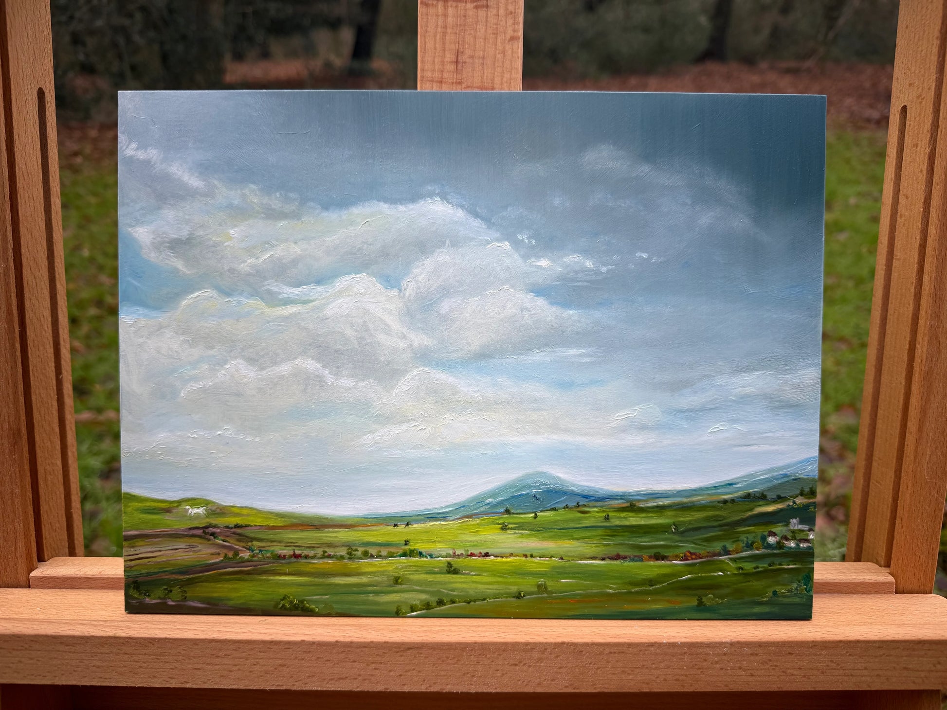 Romantic oil painting of an English countryside landscape with rolling hills and cloudy sky